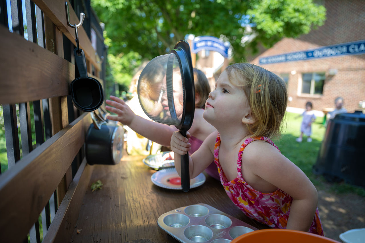 The Importance of Sensory Play Children playing with kitchen items in an outdoor classroom